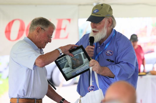 Senator James Inhofe (R-Ok.) is surprised at EAA Oshkosh 2021 with a presentation of an 11 year old photograph taken when he became only the second pilot (after George Braly) to ever pilot an aircraft operating on G100UL™ high octane unleaded avgas.